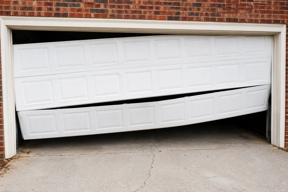 Off-track broken garage door requiring repair